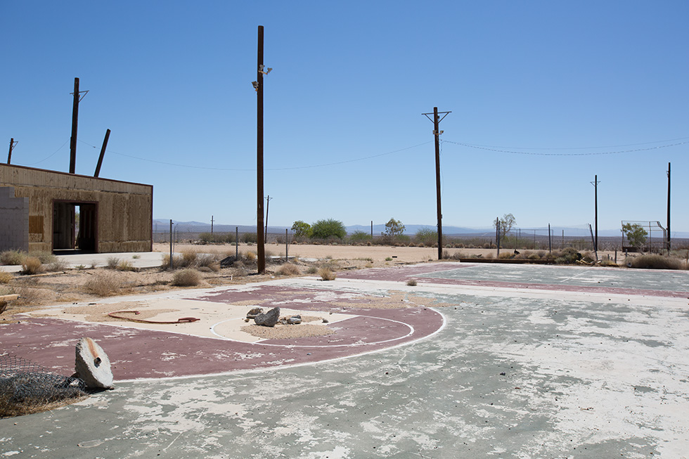 Abandoned basketball court and baseball field