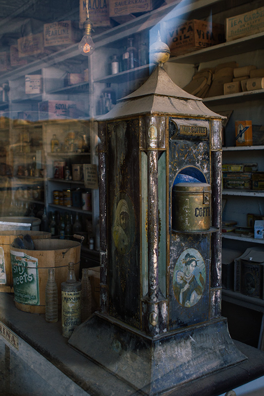 Jake Reinig Travel Photography | Bodie Ghost Town | Interior of a Store, Working Light Bulb, Coffee Machine